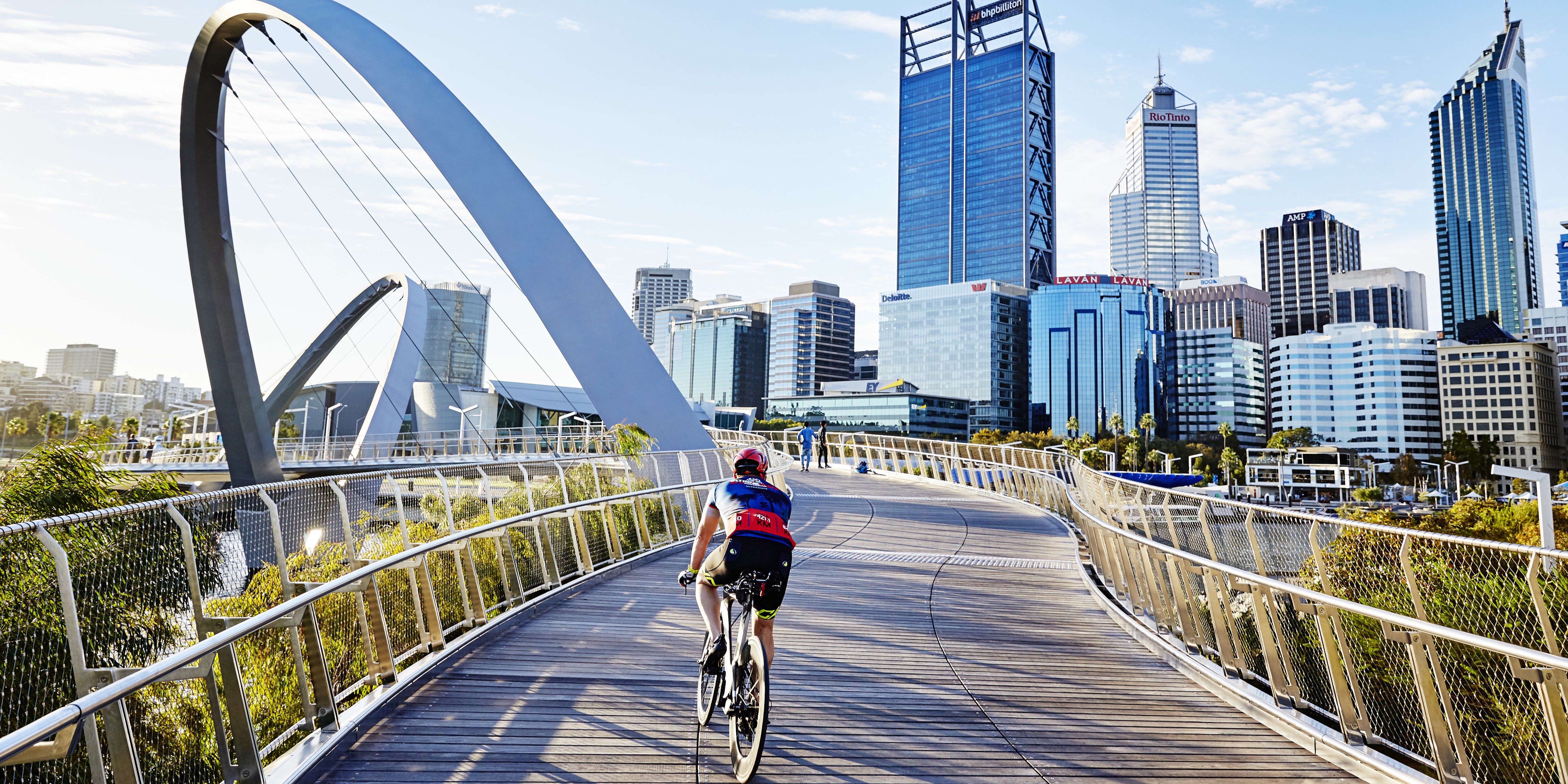 A cyclist riding on a bridge